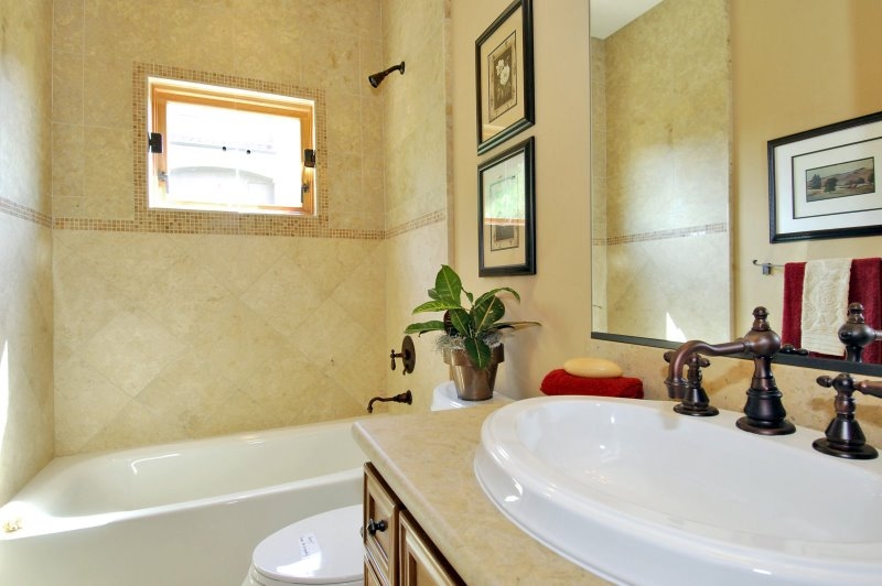 1582 Grandview BTH 4.jpg - Another long thin bathroom. Do not like the highly relieved face of the cabinets. Not my taste. Stonework is varied enough not to be boring but not too personalized either.